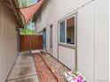 Side view of the home highlighting the entrance, walkway, and lovely landscaping at 32 Powder Horn Pl, Longmont, CO 80504