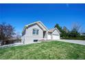 A spacious brick home with a well-maintained lawn and a two-car garage at 11606 Sagewood Ln, Parker, CO 80138