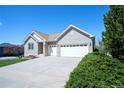 Beautiful single story brick home featuring a well-maintained lawn and a two-car garage at 11606 Sagewood Ln, Parker, CO 80138