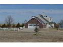 Side view of a home with a brick-facade garage and a white garage door at 74500 E 136Th Ave, Byers, CO 80103