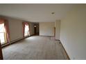 Spacious living room featuring large windows with pink curtains and neutral carpet at 74500 E 136Th Ave, Byers, CO 80103