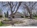 Wide driveway leading to a home with a two-car garage and landscaping at 6272 S Garfield Dr, Centennial, CO 80121