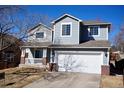 Charming two-story home features a well-maintained yard and attached two car garage at 18121 E Adriatic Pl, Aurora, CO 80013