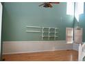 Bright living room featuring high ceilings, fresh paint and hardwood floors at 18121 E Adriatic Pl, Aurora, CO 80013