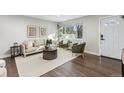 Cozy living room with modern furniture, hardwood floors, and a bright window at 2401 W 39Th, Denver, CO 80211