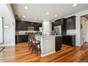 Spacious kitchen with dark wood cabinets, stainless steel appliances, granite counters, and a large center island at 17056 E 111Th Ave, Commerce City, CO 80022