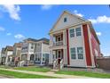 Beautiful street view of colorful homes with landscaped front yards and inviting front porches at 213 Washington St, Erie, CO 80516