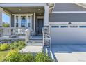 Charming front porch with beautiful stone details leads to the home's entrance and the two-car garage at 15919 Xanthia Way, Thornton, CO 80602