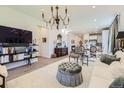 Bright living space featuring wood floors, an elegant chandelier, and contemporary furnishings at 15919 Xanthia Way, Thornton, CO 80602