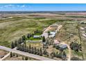 Wide aerial view of horse property with acreage, barn, outbuildings and rural surroundings; perfect for a countryside retreat at 50950 E 32Nd Ave, Bennett, CO 80102