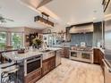 Spacious kitchen featuring stainless steel appliances, a large island, and a stylish vent hood at 50950 E 32Nd Ave, Bennett, CO 80102
