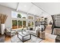 Bright, airy living room with large windows, vaulted ceilings, and stylish decor at 7743 S Birch Ct, Centennial, CO 80122