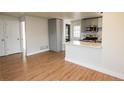 Open concept kitchen with gray cabinets, stainless steel appliances, and breakfast bar at 1564 Verbena St, Denver, CO 80220