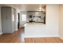 Updated kitchen featuring gray cabinets, stainless steel appliances, and an open layout at 1564 Verbena St, Denver, CO 80220