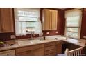 Traditional kitchen with wooden cabinets, a double sink, and ample counter space for cooking and meal preparation at 1653 Trenton St, Denver, CO 80220