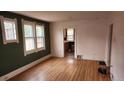 Bright living room with hardwood floors, large windows, and neutral paint, perfect for relaxation at 1653 Trenton St, Denver, CO 80220