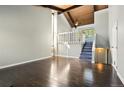 Bright living room featuring hardwood floors, vaulted ceilings and a staircase to the second level at 865 S Depew St, Lakewood, CO 80226