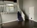 Inviting living space with staircase, hardwood floors, and natural light at 865 S Depew St, Lakewood, CO 80226