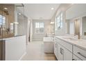 Luxurious bathroom featuring a soaking tub, dual vanities, and a walk-in shower at 3350 Backdrop Ct, Castle Rock, CO 80108