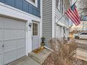 Inviting front entrance with a charming 'hello' mat, lovely potted plant, and American flag waving above at 1699 S Trenton St # 172, Denver, CO 80231