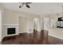Open-concept living room with a fireplace, hardwood floors, and modern finishes at 303 Inverness Way # 201, Englewood, CO 80112