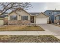 Attractive single-Gathering home with a stone accent, inviting curb appeal, and well-maintained landscaping at 10968 Macon St, Commerce City, CO 80640