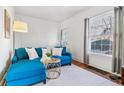 Bright living room with hardwood floors, a large window, and stylish blue sofa at 1038 E 4Th Ave, Denver, CO 80218