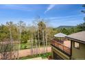 Outdoor deck view featuring table, umbrella, and mountain views surrounded by Aspen trees at 25808 Sunrise Ln, Golden, CO 80401