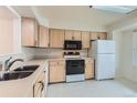 Bright kitchen with light wood cabinets and appliances at 6712 E Briarwood Dr, Centennial, CO 80112