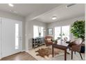 Inviting home office featuring a comfortable leather chair, a large desk, and ample natural light at 46501 Avery Ln, Bennett, CO 80102