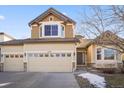 Beautiful two-story home featuring a three-car garage and a welcoming front entrance at 17118 Knollside Ave, Parker, CO 80134