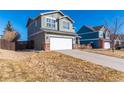 Exterior view of a two-story home showcasing the architecture and landscaping on a sunny day at 5747 E Monument Dr, Castle Rock, CO 80104