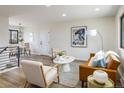 Bright living room with hardwood floors, neutral paint, and a leather sofa, creating an inviting space at 10792 Moore St, Broomfield, CO 80021