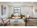 Inviting living room with stylish furnishings, hardwood floors, neutral paint and large window for natural light at 10792 Moore St, Broomfield, CO 80021