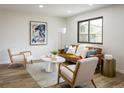Bright living room with modern decor, hardwood floors, and a comfortable leather couch at 10792 Moore St, Broomfield, CO 80021