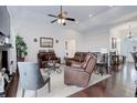 Comfortable living room with vaulted ceilings, leather seating, and hardwood floors at 38025 E 145Th Pl, Keenesburg, CO 80643