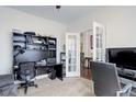 Functional office space with built-in shelving, carpeted floors, and ample natural light at 38025 E 145Th Pl, Keenesburg, CO 80643