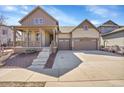 Charming two-story home features a welcoming front porch and a two-car garage at 7884 Blue River Ave, Littleton, CO 80125