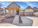 Charming two-story home features a welcoming front porch and a two-car garage at 7884 Blue River Ave, Littleton, CO 80125