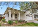 Inviting front porch featuring sturdy columns and a well-manicured garden at 12507 Dexter Way, Thornton, CO 80241