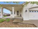 Welcoming covered front porch offering a charming entry to the home at 12507 Dexter Way, Thornton, CO 80241