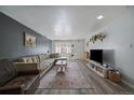 Inviting living room with comfortable seating, a large TV, and plenty of natural light at 10321 W 59Th Ave # 2, Arvada, CO 80004
