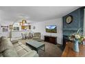 Comfortable living room with a fireplace, TV, and open layout to the dining area at 4020 E 94Th Ave # B, Thornton, CO 80229