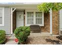 Inviting covered porch with brick accents and a cozy bench, perfect for relaxing outdoors at 4020 E 94Th Ave # B, Thornton, CO 80229