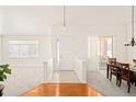 Bright and airy entryway with hardwood floors and views to dining area at 8645 Gold Peak Pl # A, Highlands Ranch, CO 80130