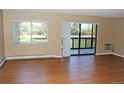 Bright living room featuring wood floors, large window, and sliding glass door to a private balcony at 14390 E Marina Dr # 204, Aurora, CO 80014