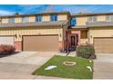 Charming townhome with a two-car garage, brick accents, and well-maintained front lawn at 18605 E Saratoga Pl, Aurora, CO 80015