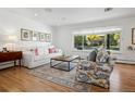 Bright living room with hardwood floors, a large window, and comfortable seating with modern decor at 2602 S Kearney St, Denver, CO 80222