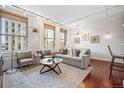 Bright, modern living room with hardwood floors, large windows, and neutral decor at 444 17Th St # 807, Denver, CO 80202