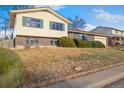 Well-maintained home features green shutters, brick accents, and a neatly landscaped front yard at 10636 Ura Ln, Northglenn, CO 80234